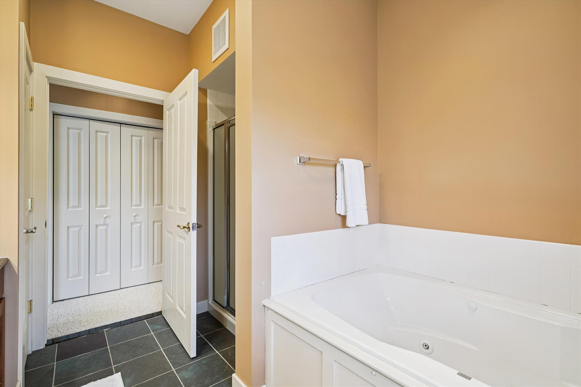 Spacious master bath with double sinks, walk-in shower, and whirlpool tub—perfect for relaxing after time on the mountain.