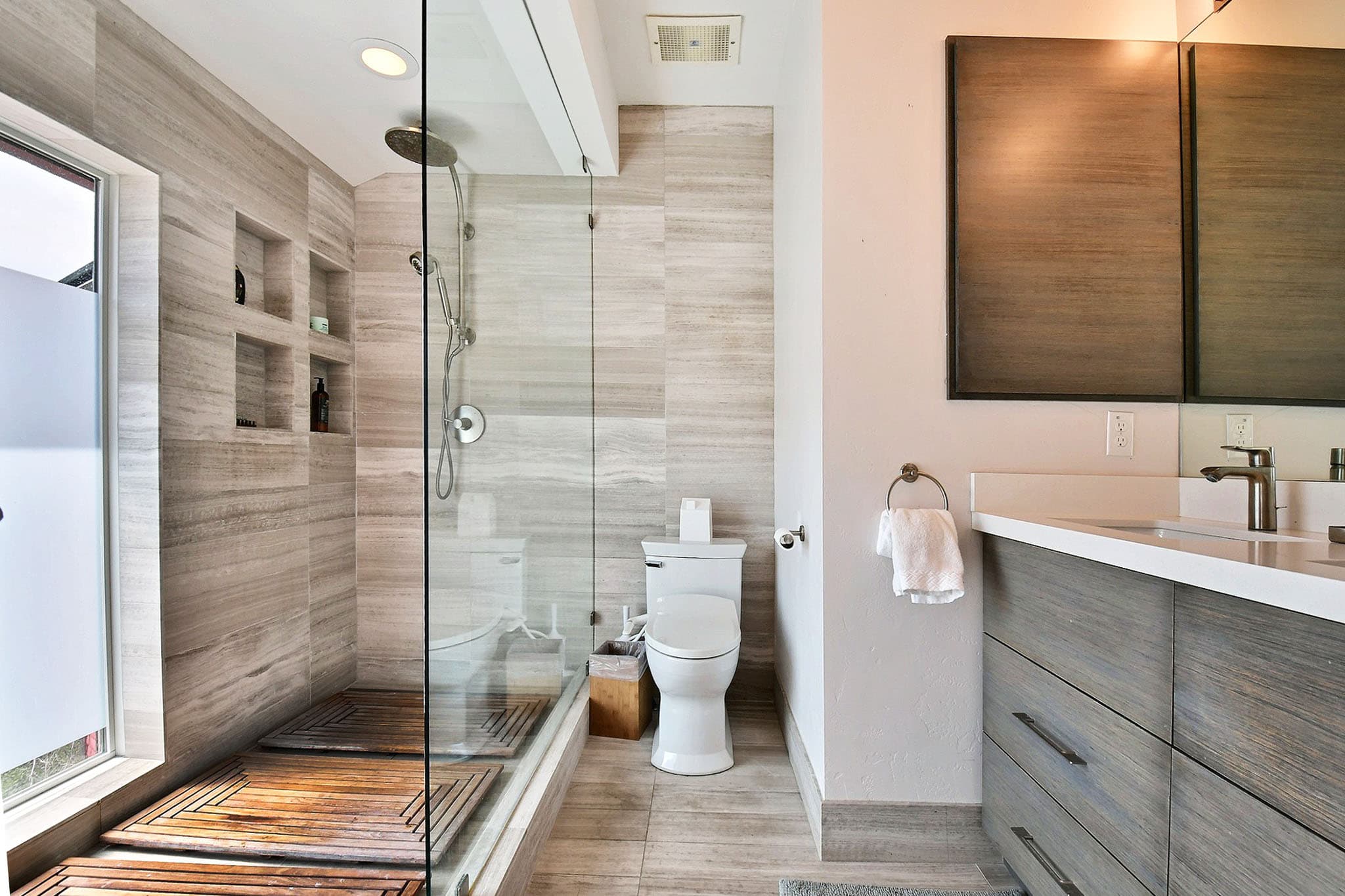 Glass Shower, Wooden Shower Floor, Toilet, Vanity, Mirror, Faucet, Towel