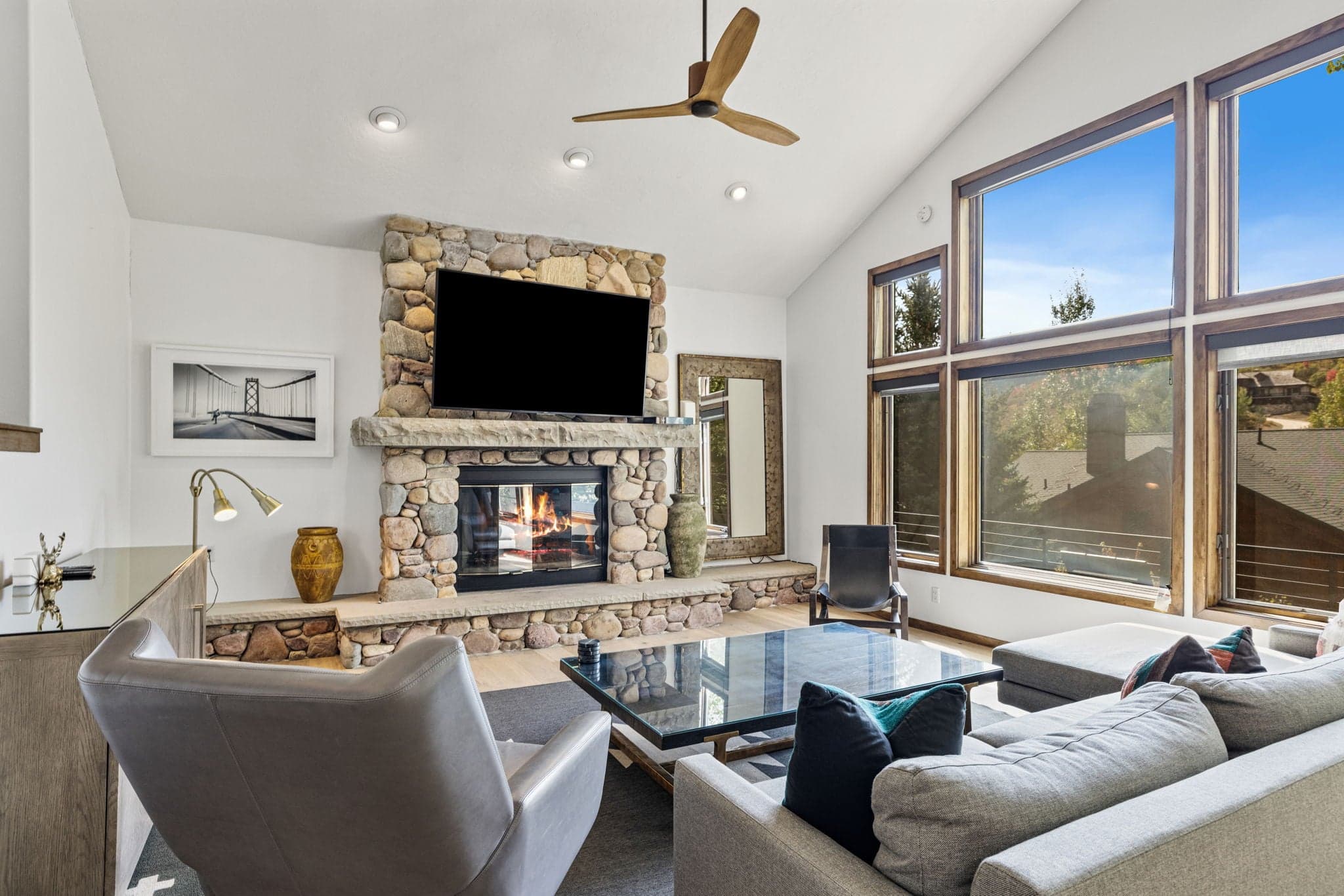Comfortable Living Room Space Featuring Stone Fireplace and Mountain Views.