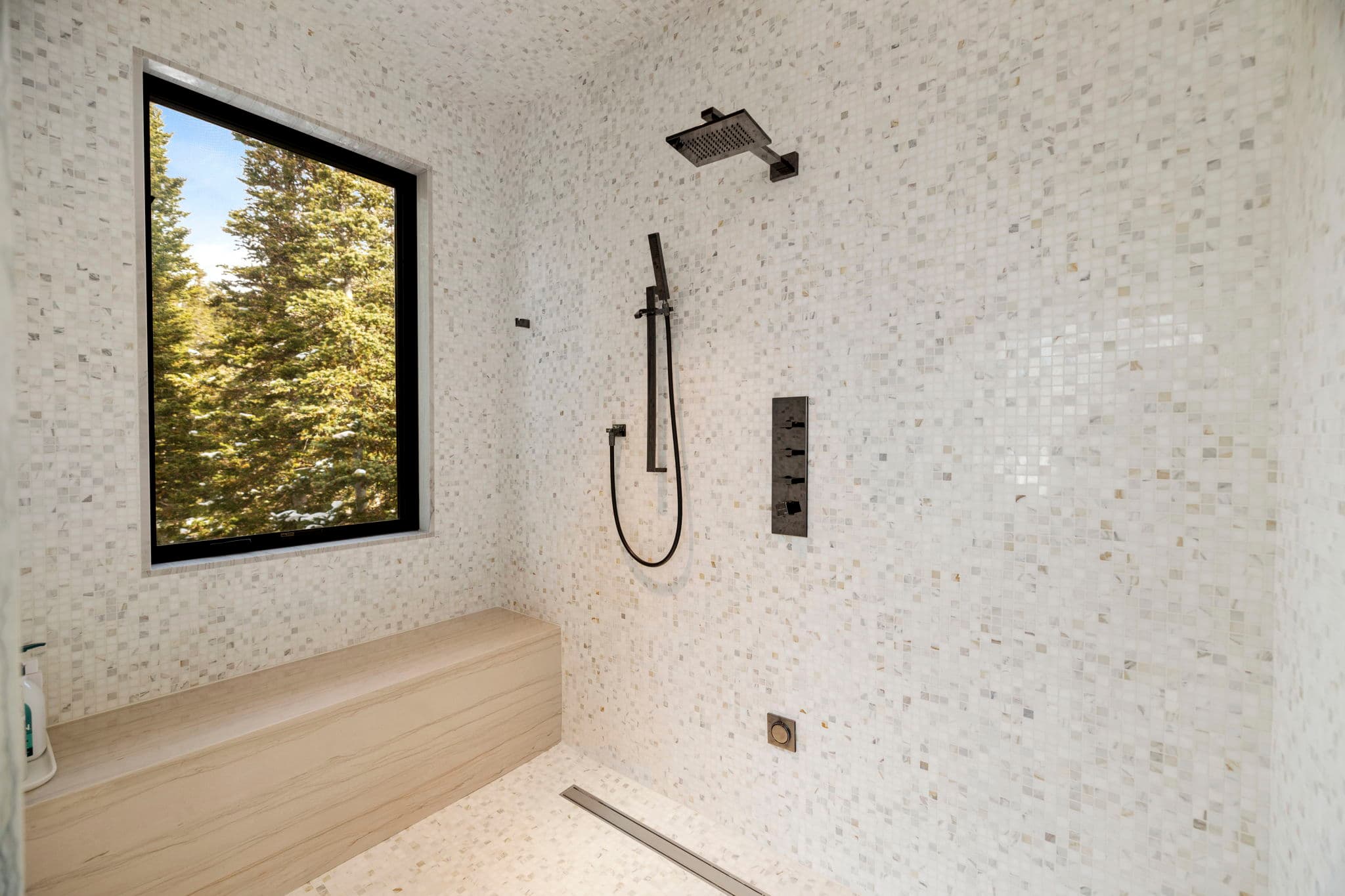 A large modern shower with a window.