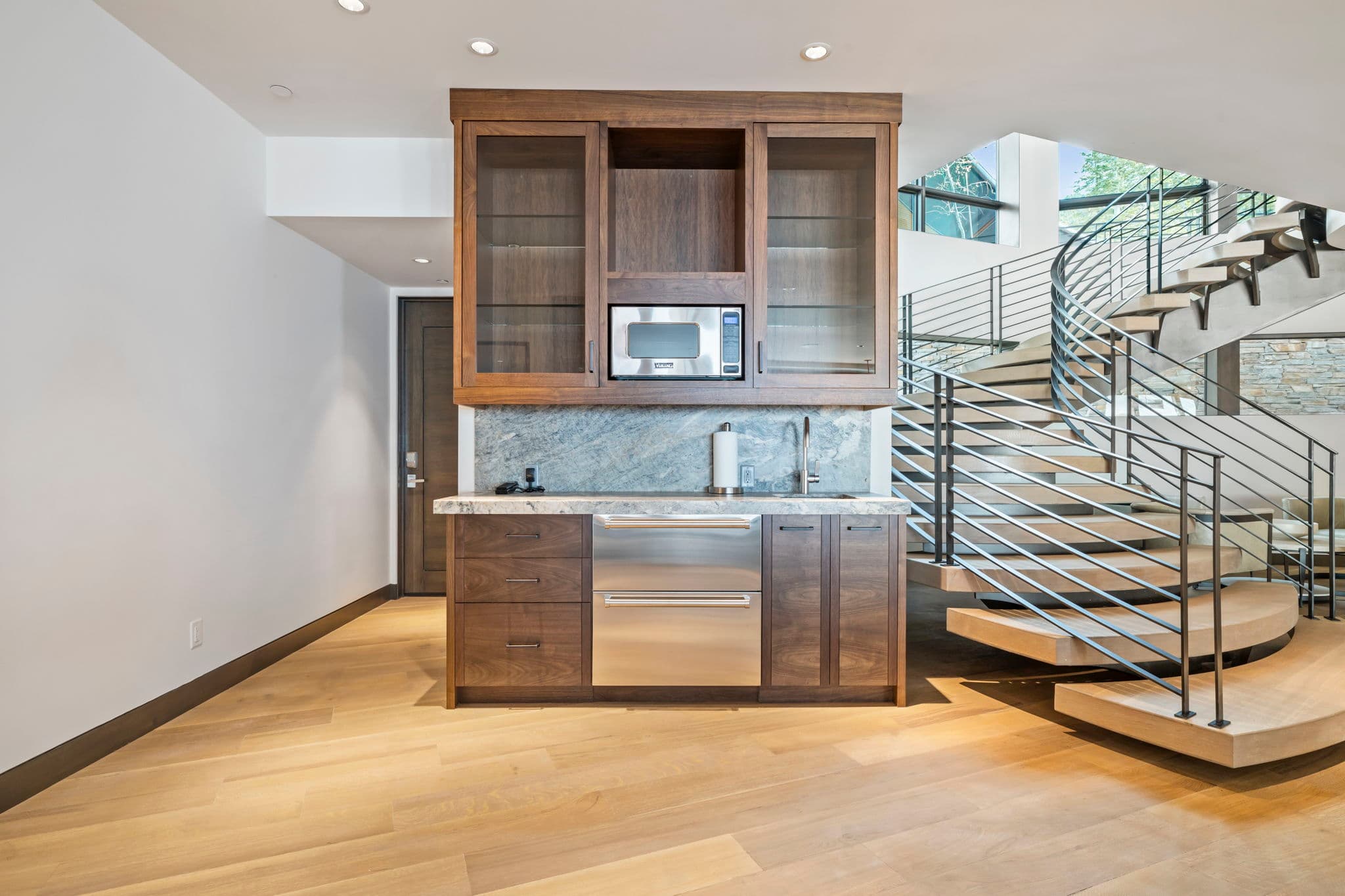 A mini kitchen area with a microwave and sink.