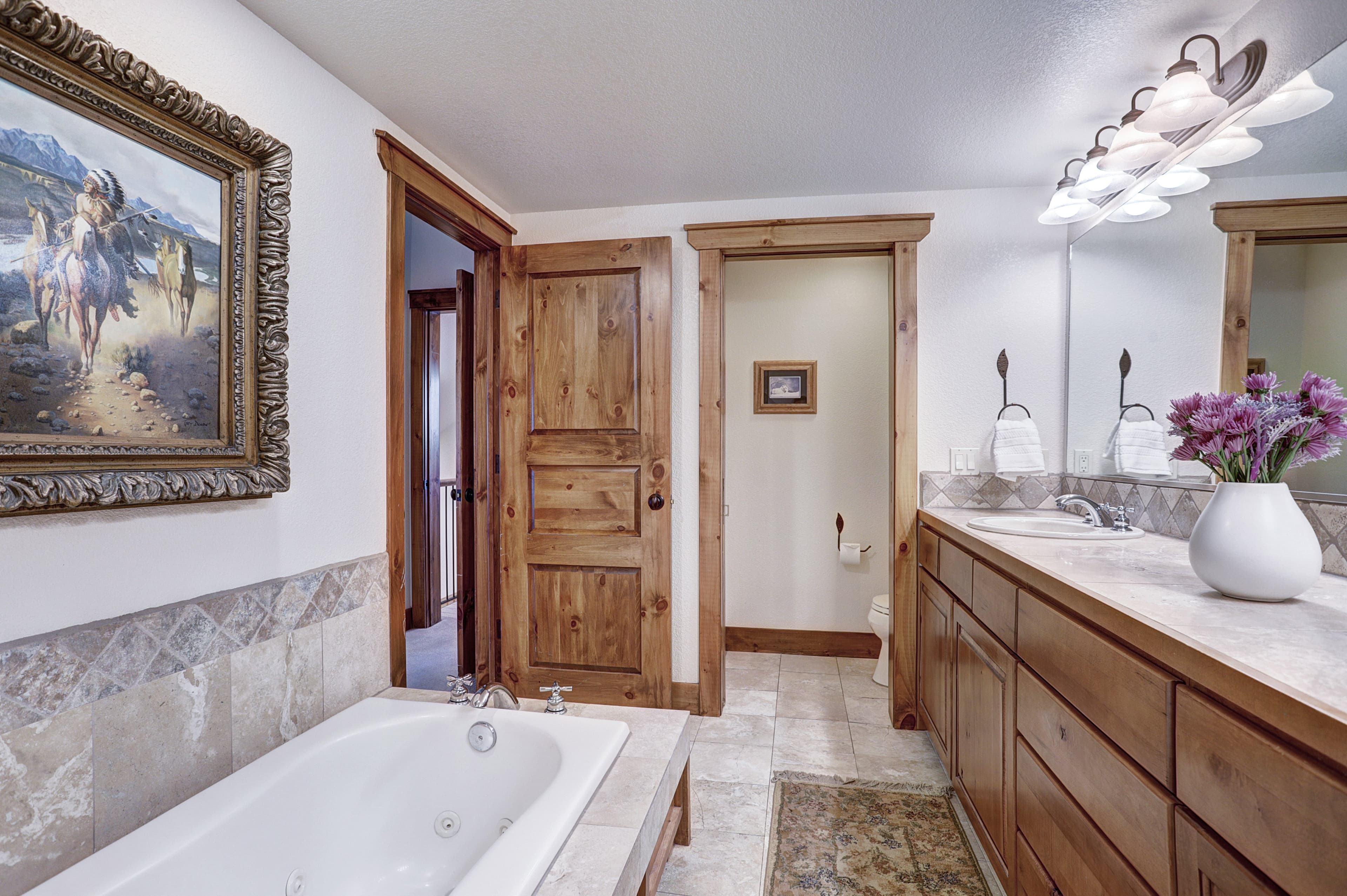 The primary bathroom offers a large bathtub, walk in shower and double vanity sinks - Amber Sky Breckenridge Vacation Rental