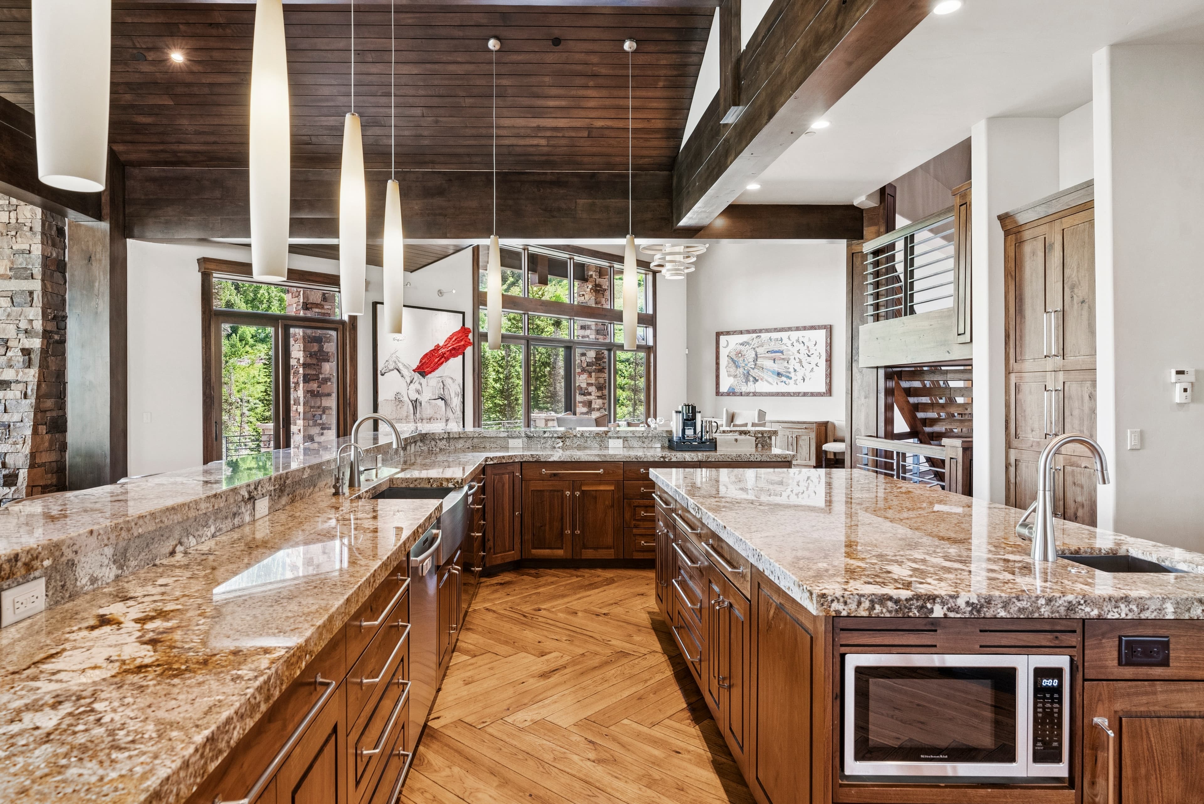 large spacious kitchen with long island, granite countertops, and designer appliances
