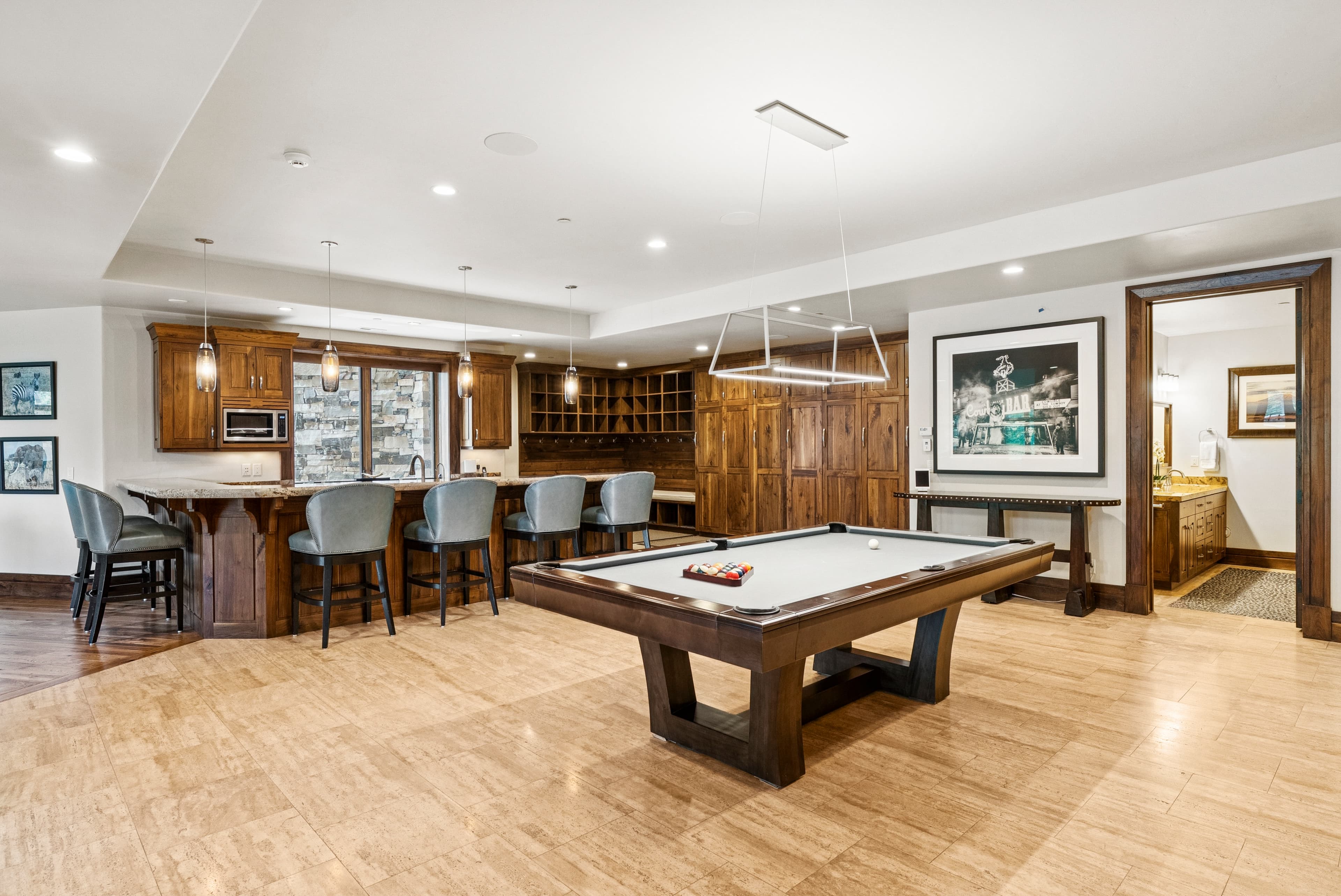 game room with pool table, bar and giant TV