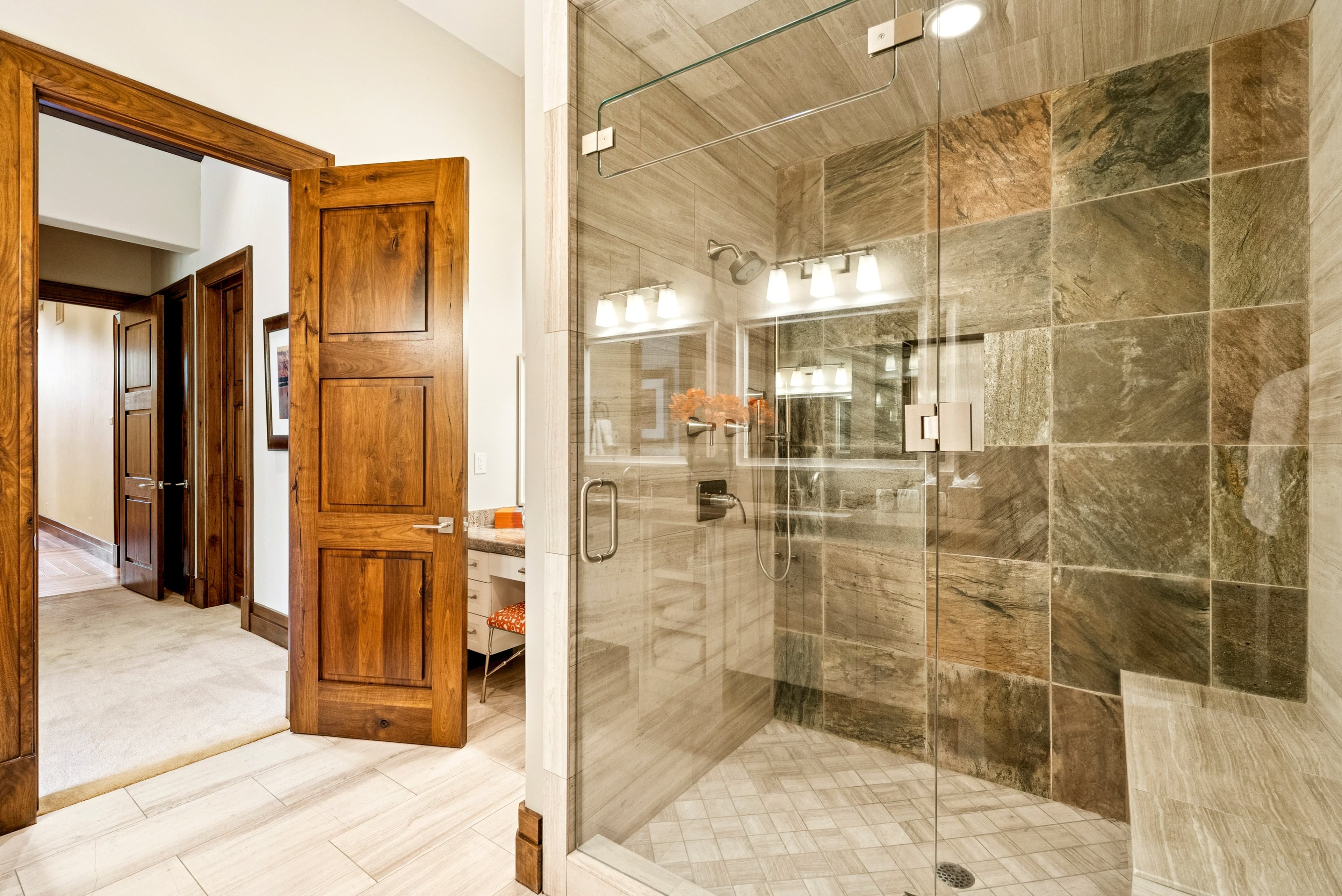 large walk in shower with marble tile at grandview